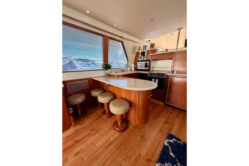 Slide: The Image of Interior of 1999 Carver 530 Voyager Pilothouse with kitchen and seating area. - 28