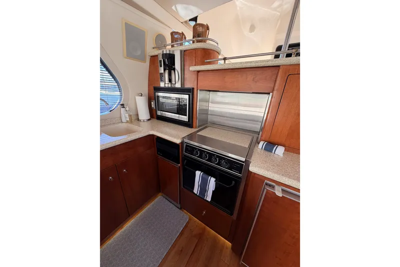 Slide: The Image of 1999 Carver 530 Voyager Pilothouse kitchen with wood cabinetry and modern appliances. - 30