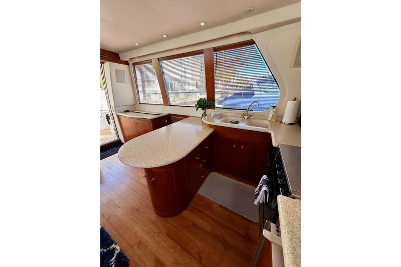 Slide: The Image of Luxurious kitchen interior of 1999 Carver 530 Voyager Pilothouse yacht with wood flooring. - 31