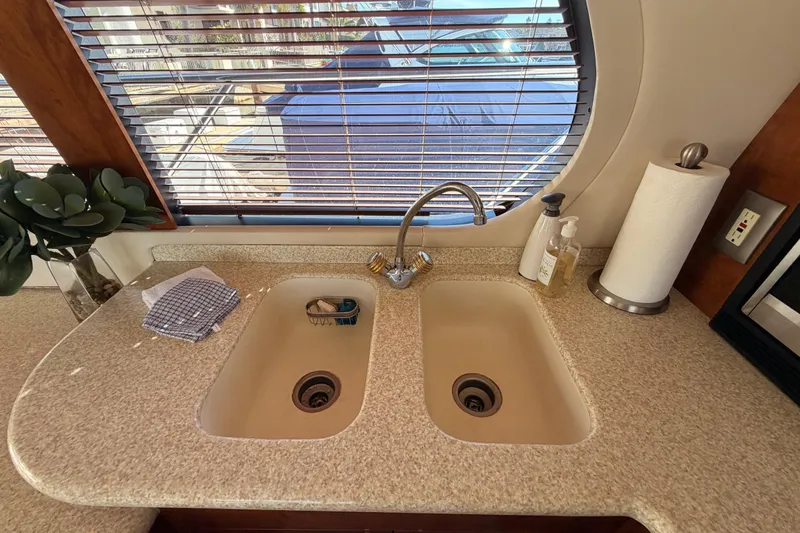 Slide: The Image of Kitchen sink area in 1999 Carver 530 Voyager Pilothouse with window view. - 32