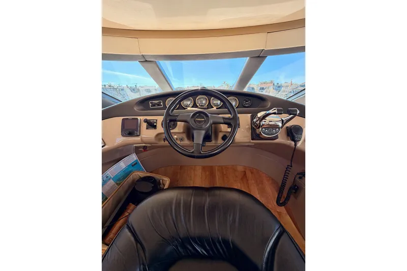 Slide: The Image of 1999 Carver 530 Voyager Pilothouse helm with steering wheel and control panel. - 43