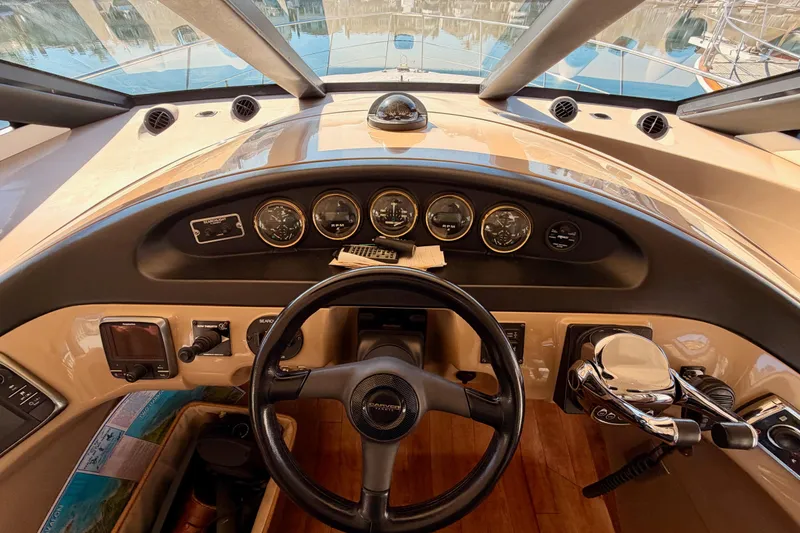 Slide: The Image of 1999 Carver 530 Voyager Pilothouse helm with gauges and steering wheel. - 46