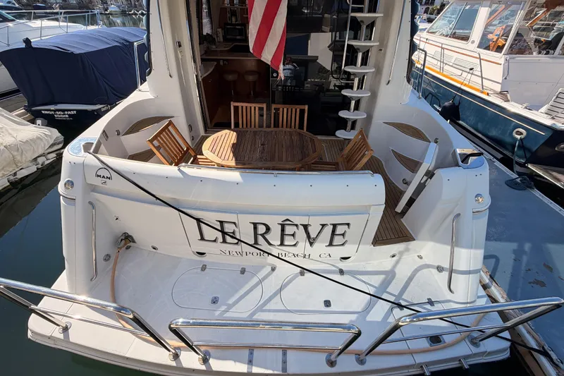 Slide: The Image of 1999 Carver 530 Voyager Pilothouse yacht with outdoor seating, docked at marina. - 5