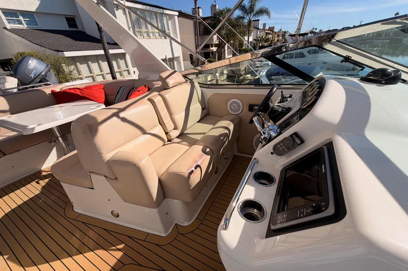 Slide: The Image of 1999 Carver 530 Voyager Pilothouse interior with beige seating and modern controls. - 51