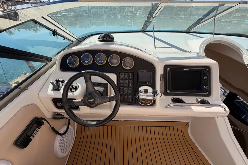 Slide: The Image of 1999 Carver 530 Voyager Pilothouse helm with steering wheel and navigation instruments. - 53