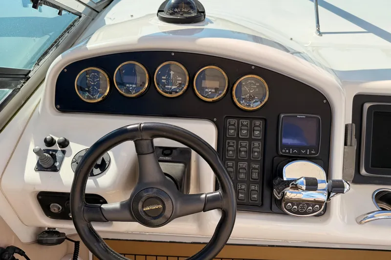 Slide: The Image of Control panel of a 1999 Carver 530 Voyager Pilothouse yacht with steering wheel and gauges. - 55