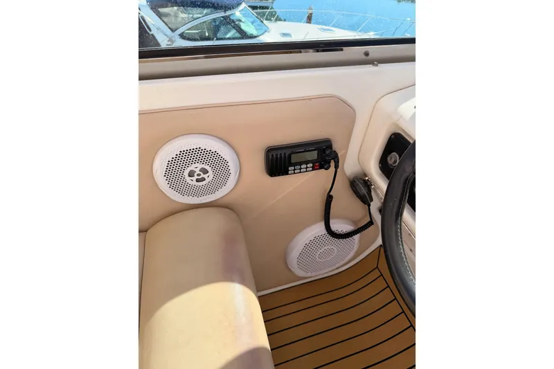 Slide: The Image of 1999 Carver 530 Voyager Pilothouse interior with radio and speakers. - 56