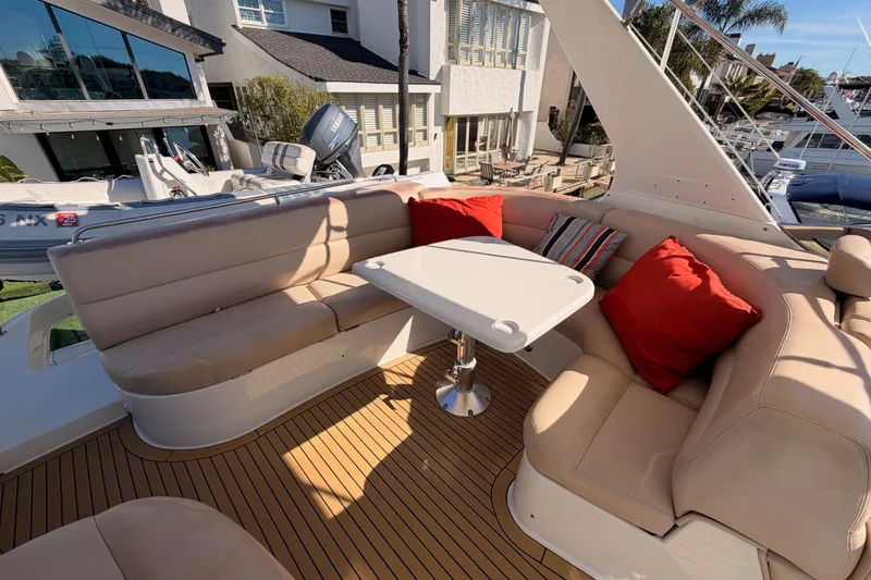 Slide: The Image of Luxurious seating area on 1999 Carver 530 Voyager Pilothouse with red cushions and table. - 60