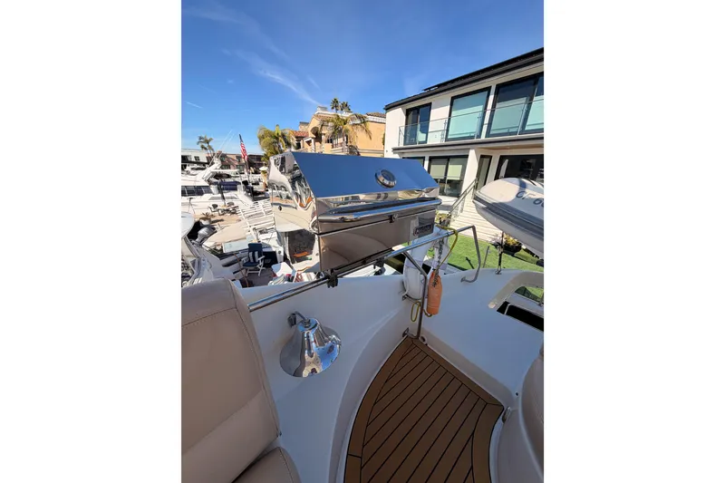 Slide: The Image of 1999 Carver 530 Voyager Pilothouse yacht deck with grill and seating area. - 62