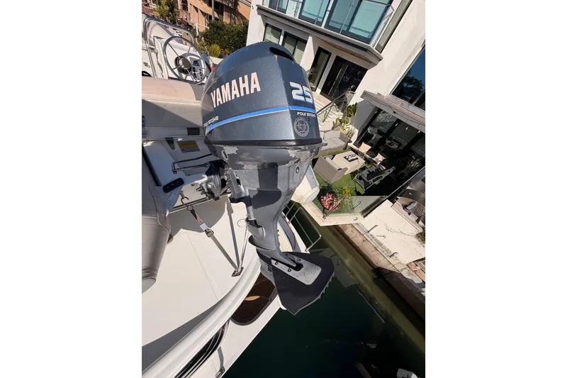 Slide: The Image of Outboard motor on 1999 Carver 530 Voyager Pilothouse, docked near modern waterfront home. - 64