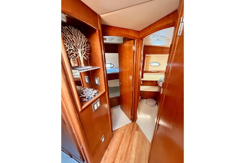 Slide: The Image of 1999 Carver 530 Voyager Pilothouse interior with wooden cabinetry and decorative shelving. - 74