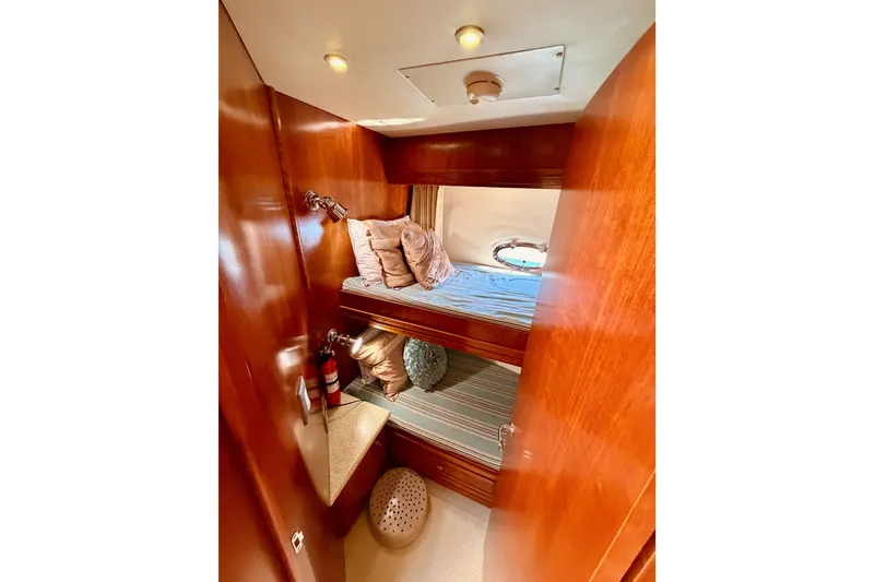 Slide: The Image of Cozy cabin interior of 1999 Carver 530 Voyager Pilothouse with bunk beds and wooden finish. - 75