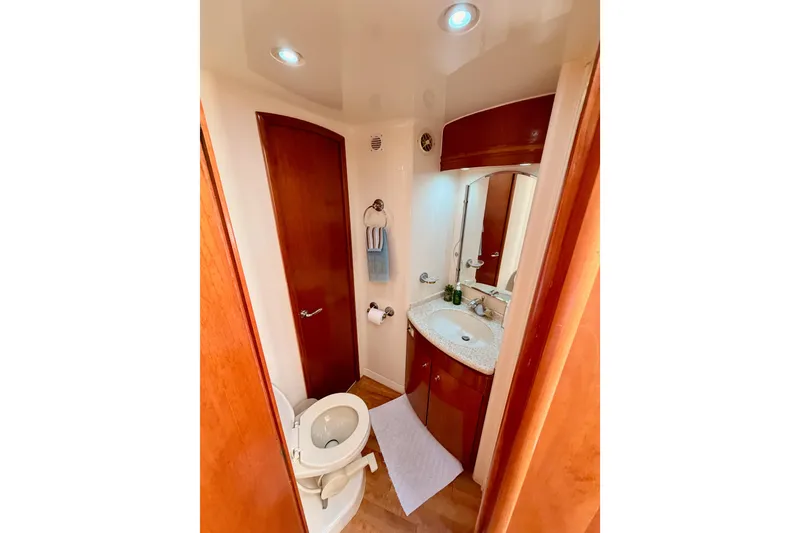 Slide: The Image of Bathroom interior of 1999 Carver 530 Voyager Pilothouse with sink, toilet, and wooden cabinetry. - 78