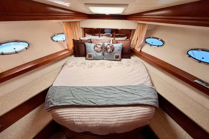 Slide: The Image of Luxurious bedroom interior of 1999 Carver 530 Voyager Pilothouse yacht with elegant bedding. - 80