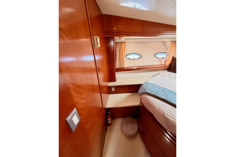 Slide: The Image of 1999 Carver 530 Voyager Pilothouse interior with wood paneling and porthole windows. - 81