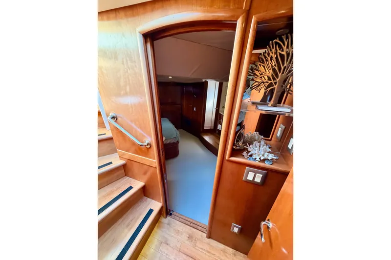 Slide: The Image of Interior of 1999 Carver 530 Voyager Pilothouse with wooden stairs and decorative shelves. - 86