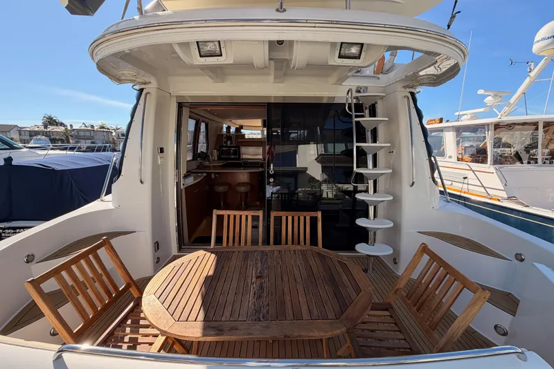 Slide: The Image of 1999 Carver 530 Voyager Pilothouse yacht with outdoor seating and spiral staircase. - 9