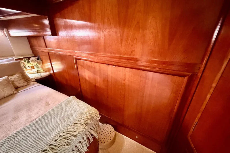 Slide: The Image of Luxurious wooden interior of 1999 Carver 530 Voyager Pilothouse yacht bedroom. - 90
