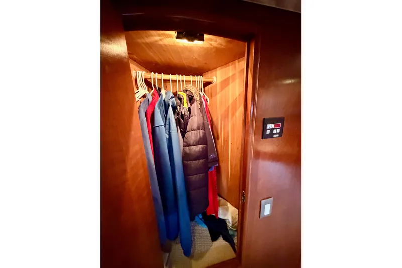 Slide: The Image of Closet inside 1999 Carver 530 Voyager Pilothouse with hanging jackets and coats. - 94