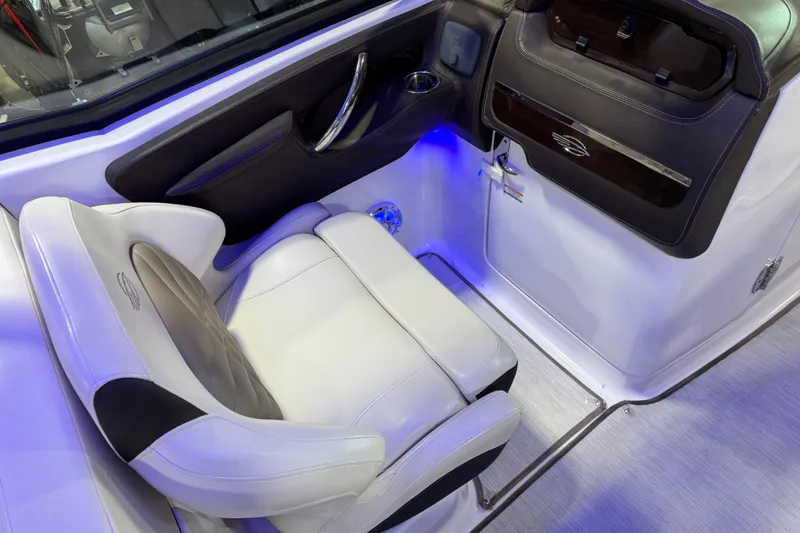 Slide: The Image of 2019 Chaparral 317 SSX boat interior with luxurious seating and ambient lighting. - 11
