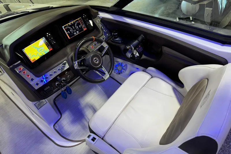 Slide: The Image of 2019 Chaparral 317 SSX boat cockpit with modern controls and navigation displays. - 12