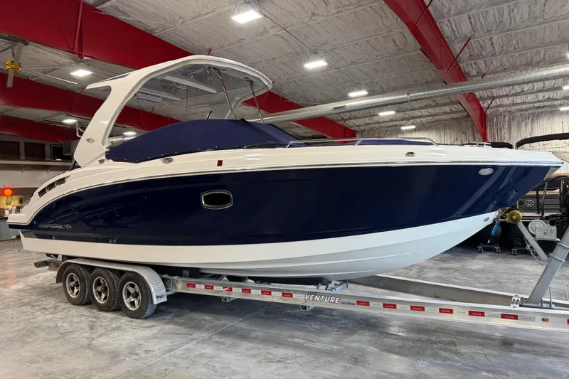 Slide: The Image of 2019 Chaparral 317 SSX boat interior with beige seating and blue LED lighting. - 15