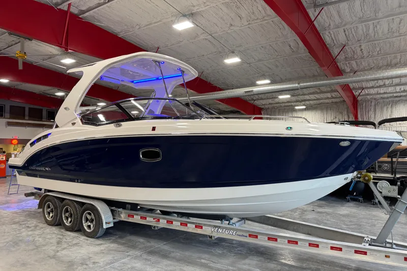Slide: The Image of 2019 Chaparral 317 SSX boat on trailer in indoor storage facility. - 2