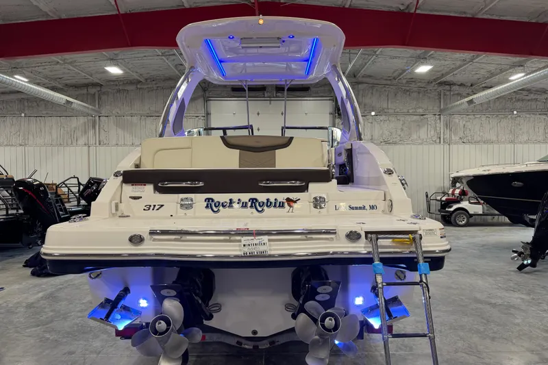 Slide: The Image of 2019 Chaparral 317 SSX boat in showroom, illuminated with blue lights. - 5