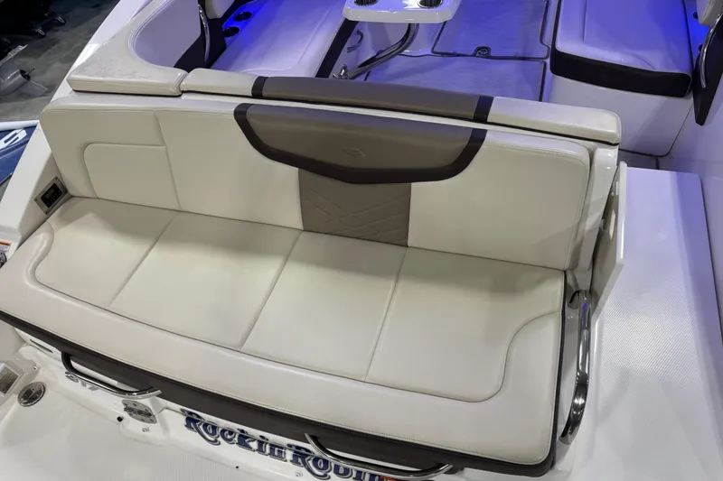 Slide: The Image of 2019 Chaparral 317 SSX boat interior with white leather seating and blue ambient lighting. - 6