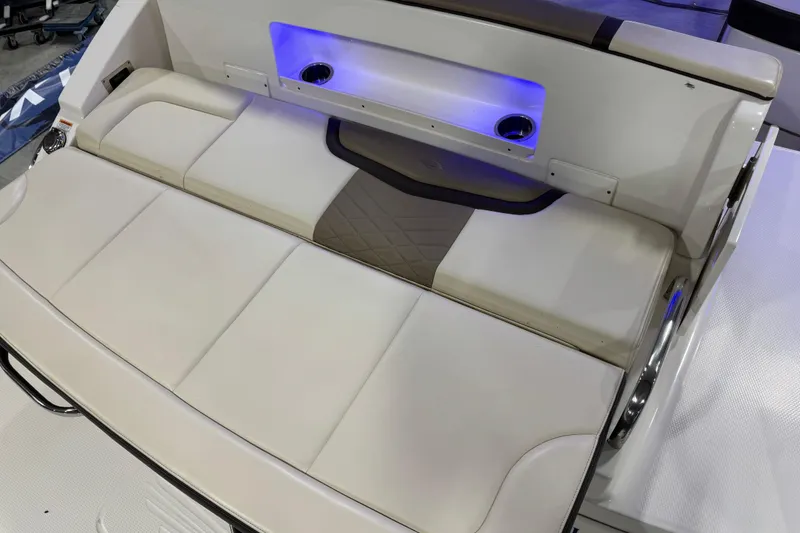Slide: The Image of 2019 Chaparral 317 SSX boat interior with cushioned seating and blue LED lighting. - 7