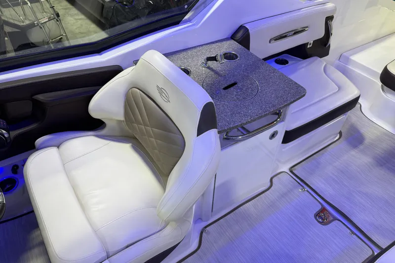 Slide: The Image of Interior of 2019 Chaparral 317 SSX boat with luxurious seating and table setup. - 8