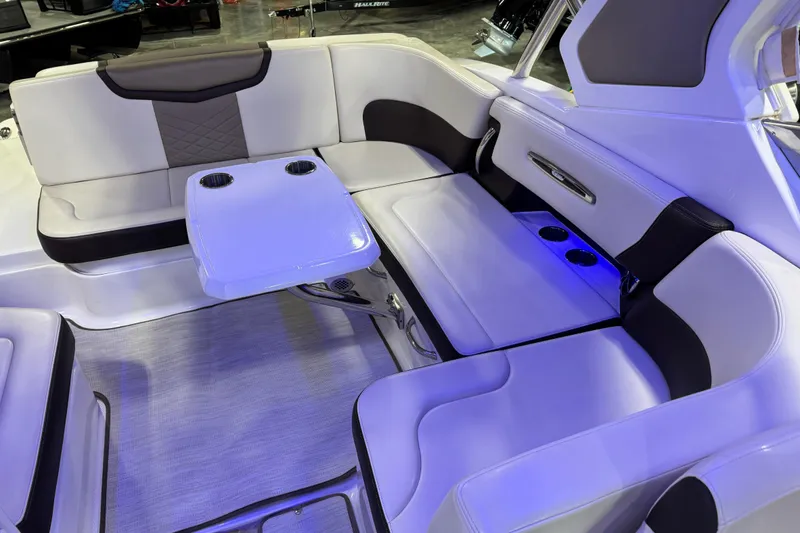 Slide: The Image of Luxurious seating area on 2019 Chaparral 317 SSX boat with table and cup holders. - 9