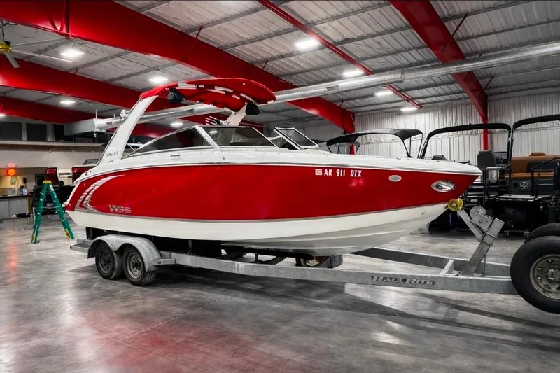 The Image of 2014 Cobalt R5 WSS boat in a garage, red and white design on a trailer. - 0