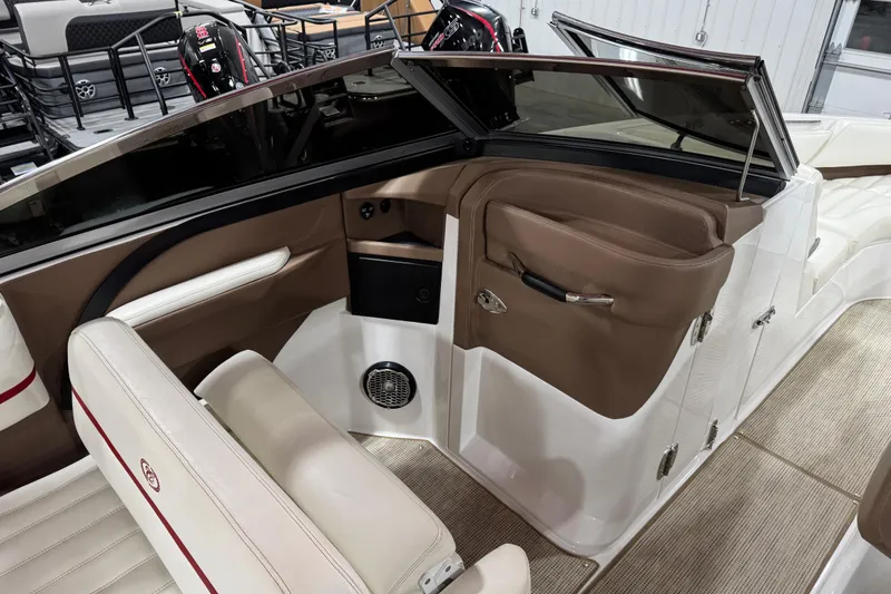 Slide: The Image of 2014 Cobalt R5 WSS boat interior with white leather seating and carpeted floor. - 12