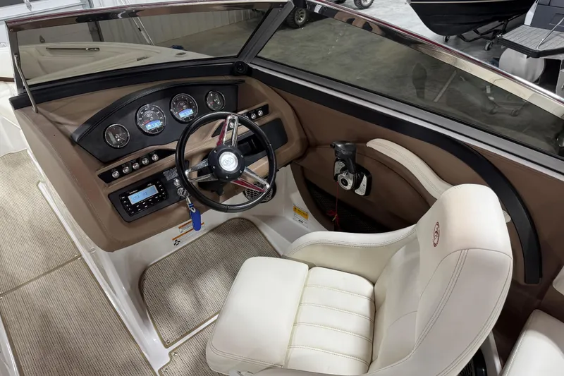 Slide: The Image of Interior of a 2014 Cobalt R5 WSS boat with beige seating and brown accents. - 13