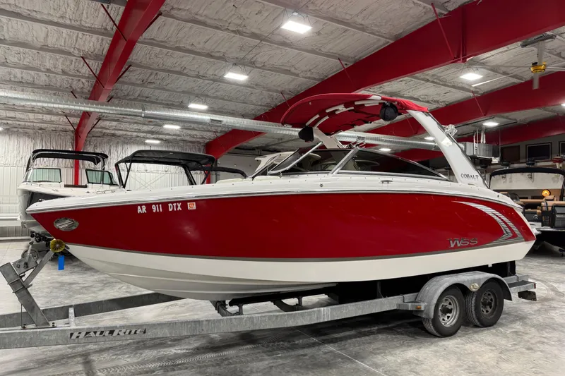 Slide: The Image of 2014 Cobalt R5 WSS boat in red and white on a trailer in a warehouse. - 2