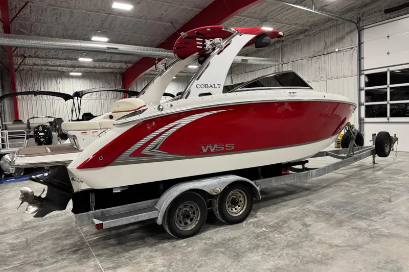 Slide: The Image of 2014 Cobalt R5 WSS boat in a garage, red and white design on trailer. - 4