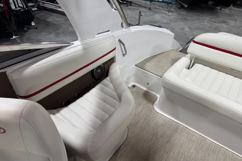 Slide: The Image of 2014 Cobalt R5 WSS boat interior with white and brown seating, red accents, and steering console. - 8