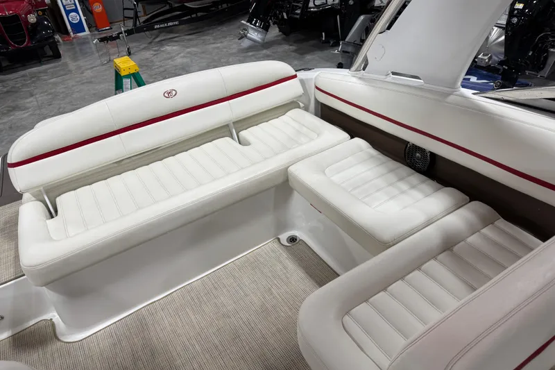 Slide: The Image of 2014 Cobalt R5 WSS boat interior with white leather seating and red accents. - 9