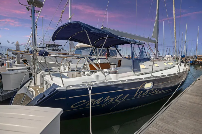 The Image of Jeanneau Sun Odyssey 52.2 sailboat docked at marina, 2001 model, under vibrant sunset sky. - 0