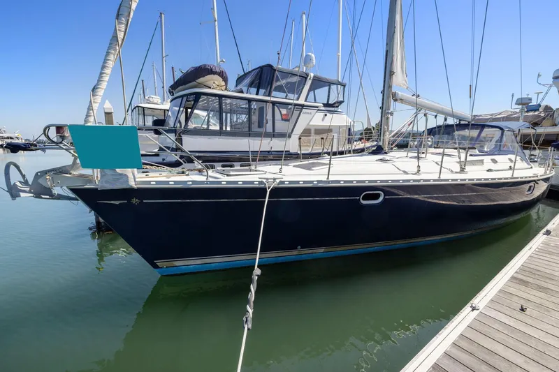 Slide: The Image of 2001 Jeanneau Sun Odyssey 52.2 sailboat docked in marina, clear blue sky. - 1