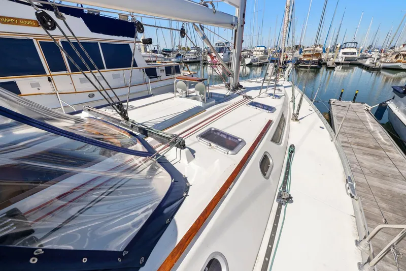 Slide: The Image of 2001 Jeanneau Sun Odyssey 52.2 sailboat docked in a marina, showcasing deck details. - 10