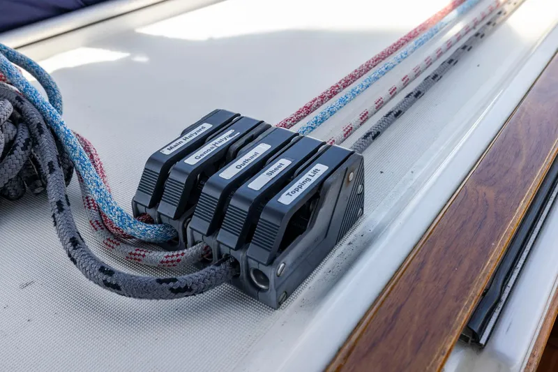 Slide: The Image of Close-up of sailing rope clutches on a 2001 Jeanneau Sun Odyssey 52.2 yacht. - 15