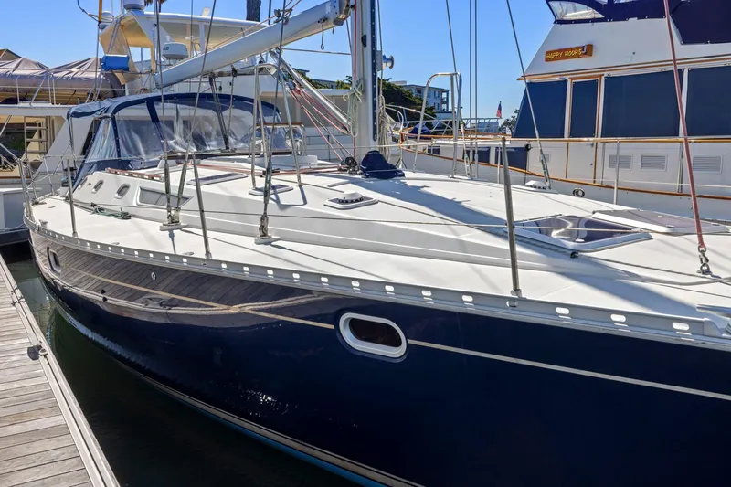 Slide: The Image of 2001 Jeanneau Sun Odyssey 52.2 sailboat docked at marina, side view. - 2