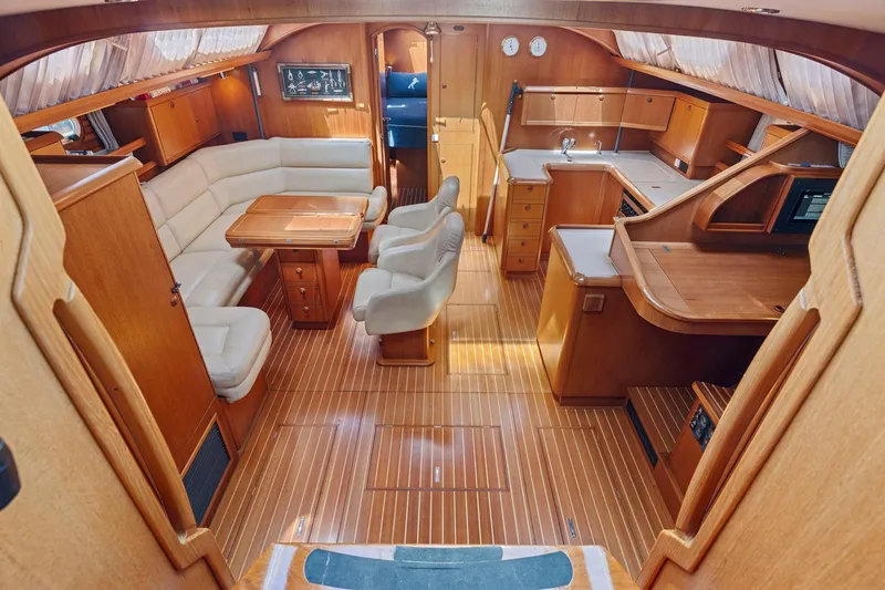 Slide: The Image of Luxurious interior of 2001 Jeanneau Sun Odyssey 52.2 yacht with wood finish and seating area. - 20