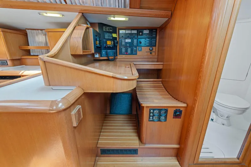 Slide: The Image of Interior of 2001 Jeanneau Sun Odyssey 52.2 yacht with navigation panel and wooden finish. - 23