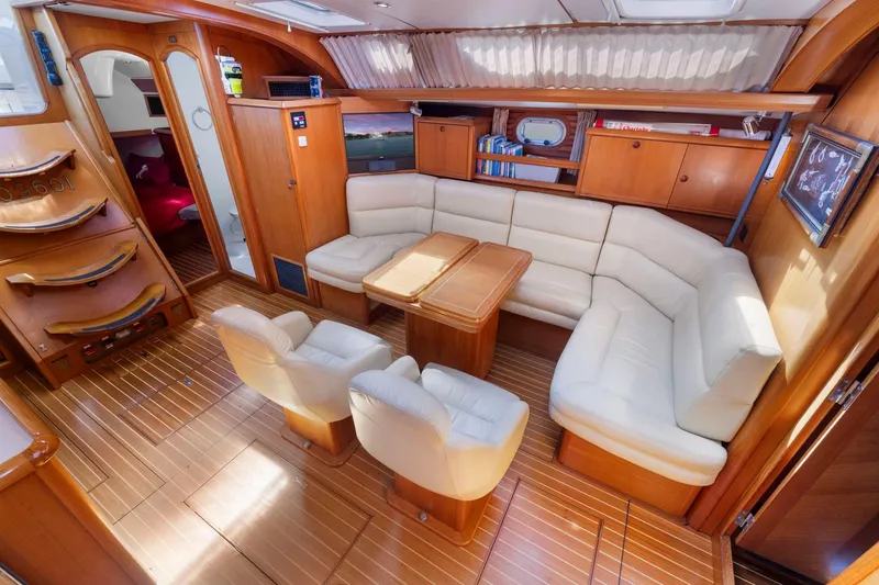 Slide: The Image of Luxurious interior of 2001 Jeanneau Sun Odyssey 52.2 yacht with elegant seating and wood finish. - 26