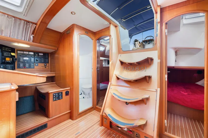 Slide: The Image of Interior of 2001 Jeanneau Sun Odyssey 52.2 sailboat, featuring wood paneling and cozy cabin spaces. - 27