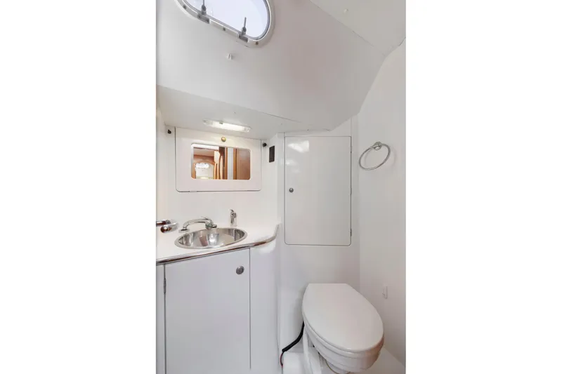 Slide: The Image of Bathroom interior of 2001 Jeanneau Sun Odyssey 52.2 yacht, featuring sink and toilet. - 28
