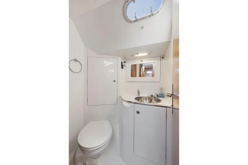 Slide: The Image of Bathroom interior of 2001 Jeanneau Sun Odyssey 52.2 yacht, featuring sink and toilet. - 29